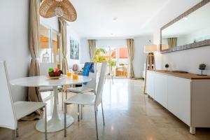 a kitchen and dining room with a table and chairs at Exclusive Villa FRANJULY Playa Paraiso Ocean View Private Pool Large Terrace in Adeje