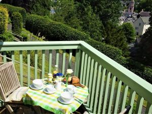 a table with a tea set on a balcony at Cottage in Jedburgh near Historic Abbey in Jedburgh +32 photos