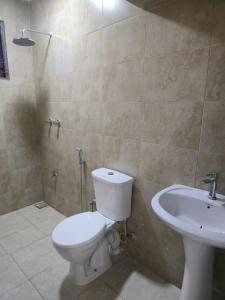 a bathroom with a toilet and a sink at 2Bdr private home in Nyali in Mombasa