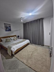 a bedroom with a large bed and a large window at 2Bdr private home in Nyali in Mombasa