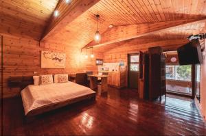 a bedroom with a bed in a wooden room at החזון של עדן in H̱azon