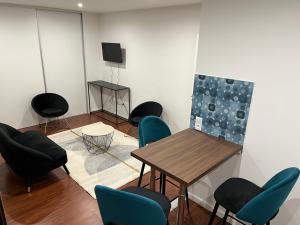 a room with chairs and a table and a painting at Disneyland Paris-Meaux 20 minutes in Meaux