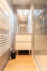 a bathroom with a shower and a sink and a glass door at Résidence Cokott - 4 Pièces pour 8 Personnes MAE-2403 in Bessans