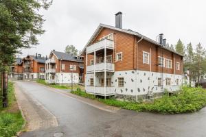 a large wooden house on the side of a street at Hiihtäjänkuja 5 B 3 Visit Levi in Levi