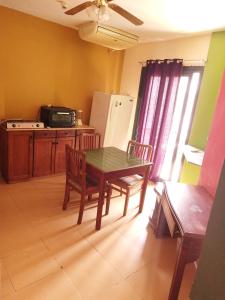 a kitchen with a table and chairs and a refrigerator at MARIA HOSTEL FOREIGNERS ONLY-CRISS RESORT-NAAMA BAY-CITY CeNTER in Sharm El Sheikh