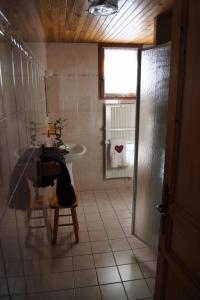 a bathroom with a sink and a table and a chair at Résidence Andagne - Appartement spacieux bien situé MAE-2423 in Bessans