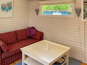 a living room with a couch and a coffee table at 4 person holiday home in Stege-By Traum in Pollerup Kullegård