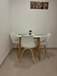 una mesa con cuatro sillas y una maceta en ella en Studio apartman Karli, en Rijeka