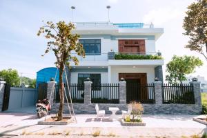 a house with a scooter parked in front of it at Sunny Villa Hà Tiên in Ha Tien
