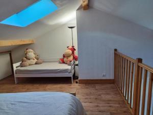two teddy bears sitting on a bed in a bedroom at Résidence Lanslevillard Quartier Eglise - Le Flocon des Bois MAE-2503 in Lanslevillard