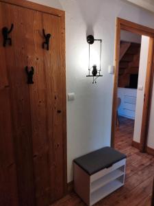a room with a wooden door and a stool at Résidence Lanslevillard Quartier Eglise - Le Flocon des Bois MAE-2503 in Lanslevillard