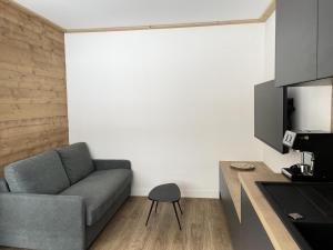 a living room with a couch and a chair at Résidence Cokott - 2 Pièces pour 4 Personnes MAE-2573 in Bessans +4 photos