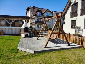 a playground in the yard of a house at Fajne Domki in Jastarnia