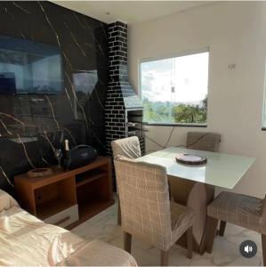 a living room with a table and a fireplace at JJs flat serra negra in Bezerros