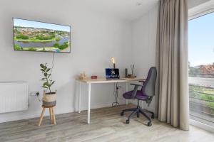 an office with a desk and a chair and a window at City Pulse Studio - Short Stays UK in Exeter