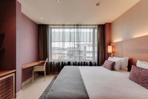 a hotel room with a large bed and a window at Hotel Badalona Tower in Badalona +33 photos