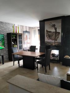 a dining room with a wooden table and chairs at Pavillon Luxe - Jardin de l'Atlas - Golf & Waky in Sraghna +35 photos