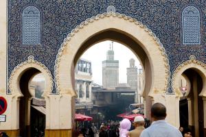 a group of people walking through an archway in a city at Barceló Fès Medina in Fez +126 photos