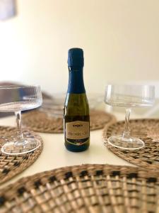 a bottle of wine and two glasses on a table at Apartament Nasypowa 3 in Gdynia