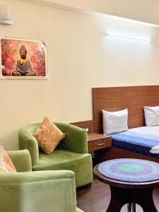 a room with a bed and a couch and a table at Skydeck by 2nd Homes in Dehradun