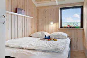 a bedroom with a bed with toys on it at 30430-Odder-Strandvaenget-15 in Odder
