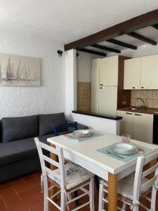 a living room with a table and a couch at Casa Azzurra in La Guardia +6 photos