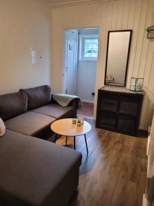 a living room with a couch and a table at Hybelleilighet - Privat - no parking in Tromsø