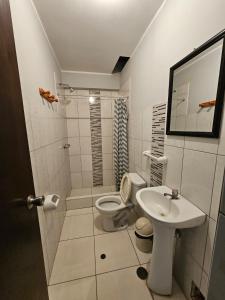a bathroom with a toilet and a sink at hostal posada del sol in San Antonio