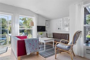 a living room with a couch and a table and chairs at 30038-Beder-Hogevaenget-15 in Beder