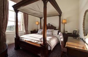 a bedroom with a canopy bed and a window at Macdonald Bath Spa Hotel in Bath