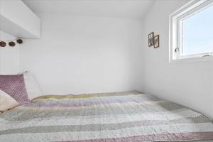 a white room with a bed with a window at 40314-Juelsminde-Asbo-14 in Sønderby +35 photos