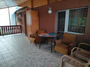 a room with a table and chairs on a balcony at Apartament S&F in Dej