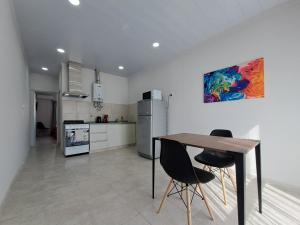 a kitchen with a table and two chairs in it at Pasaje Misiones in Paraná
