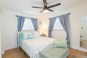 a bedroom with a bed and a ceiling fan at Madeira Beach retreat in Seminole +47 photos