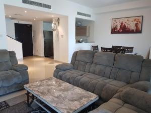 a living room with two couches and a coffee table at Nasmah Star in Juffair