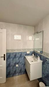 a bathroom with a sink and a mirror at BeachFront Apartment in Gandia in Puerto de Gandía +31 photos