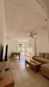 a living room with a couch and a table at BeachFront Apartment in Gandia in Puerto de Gandía