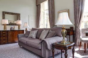
a living room filled with furniture and a large window at Macdonald Bath Spa Hotel in Bath
