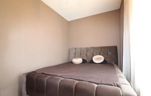 a bedroom with a bed with two pillows on it at Ultra Luxurious Apartment in Laplje Selo