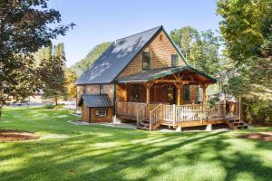 a log cabin with a porch and a deck at Fall Foliagepetshot Tubholderness School 15 Min in Holderness