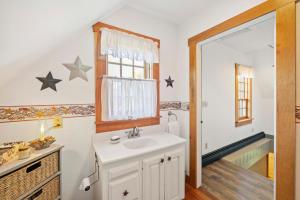 a bathroom with a sink and a mirror at Fall Foliagepetshot Tubholderness School 15 Min in Holderness +27 photos