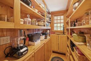 a kitchen with wooden cabinets and a blender on a counter at Fall Foliagepetshot Tubholderness School 15 Min in Holderness