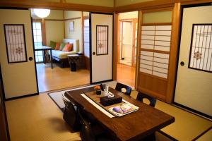 a room with a wooden table and a living room at Suzuri硯 in Takayama