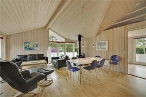 a living room with a table and chairs at 30410-Odder-Hulager-2 in Odder