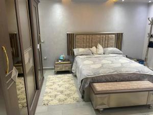 a bedroom with a large bed with a wooden headboard at اكتوبر الحصري 6 October in 6th Of October +24 photos