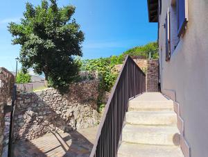a staircase with a fence next to a stone wall at Cà Dossa in Padergnone