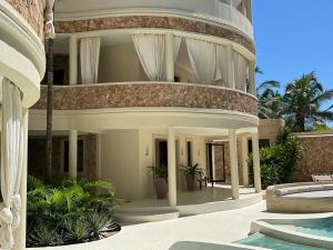 an external view of a building with a swimming pool at Casa Binti Ghepard Towers in Watamu