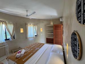 a bedroom with a large bed in a room at Casa Binti Ghepard Towers in Watamu +21 photos