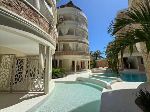 an exterior view of a building with a swimming pool at Casa Binti Ghepard Towers in Watamu