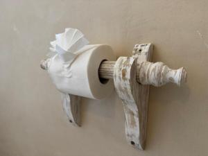 a roll of toilet paper hanging on a wall at Casa Binti Ghepard Towers in Watamu